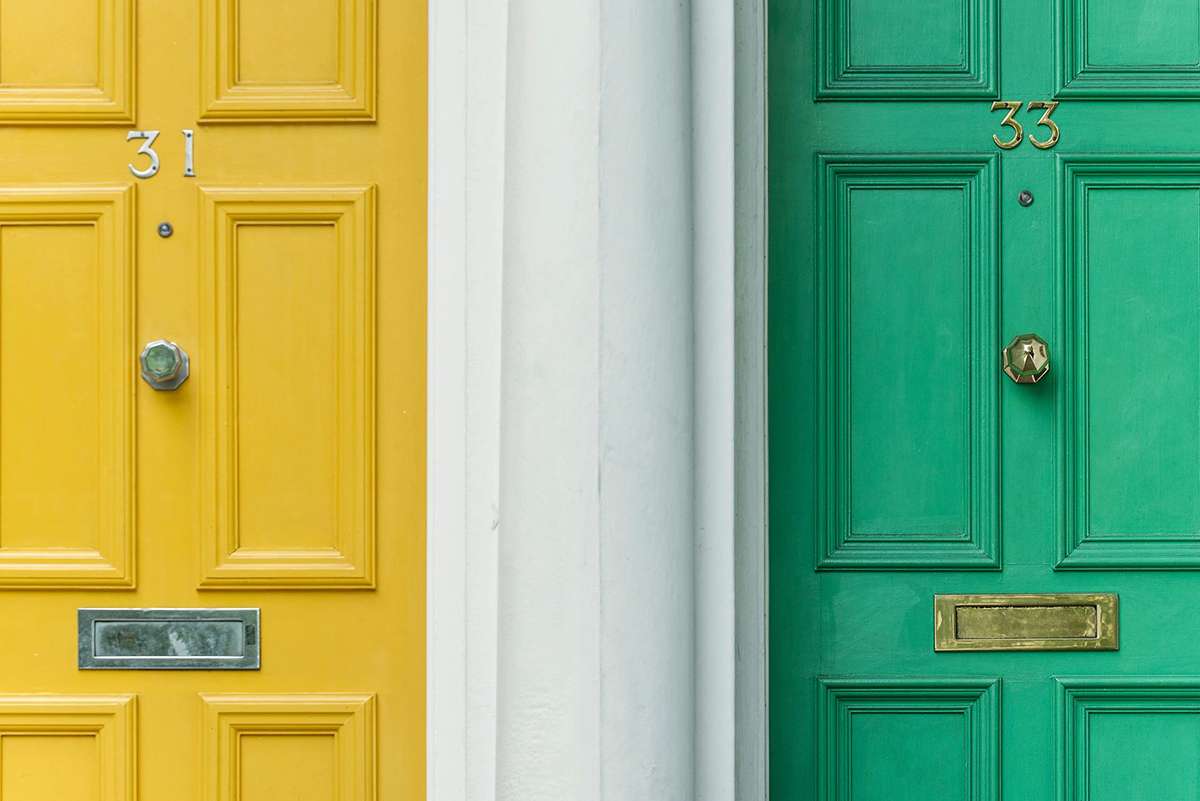 House entrances showing two doors in yellow and green