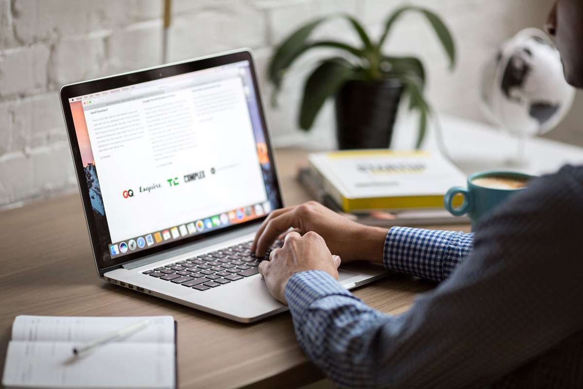 Man on desk with laptop researching