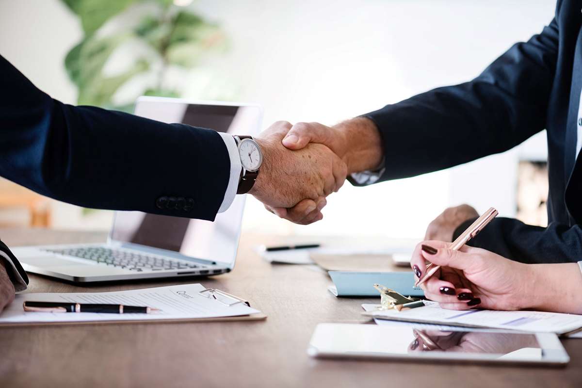 Two people shaking hands making a deal