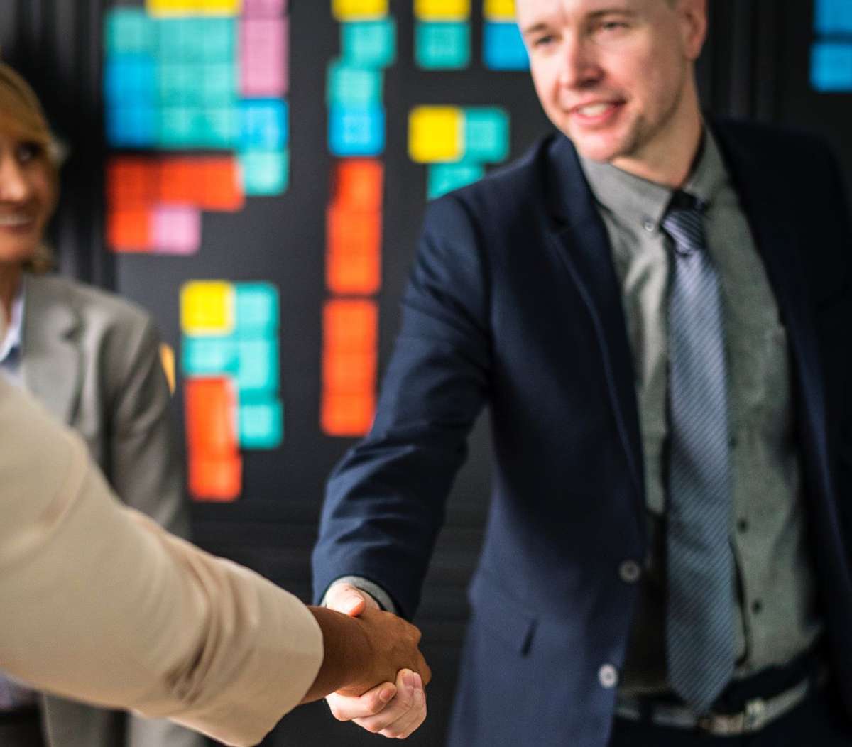 Two people shaking hands making a deal